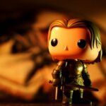 A cute toy figure in armor with dramatic light and warm tones, perfect for creative projects.